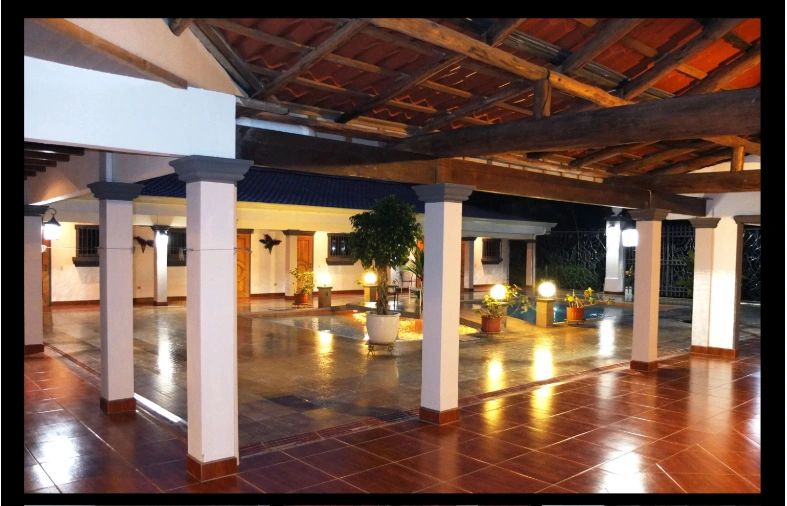Covered courtyard with terracotta tile floors and warm lighting